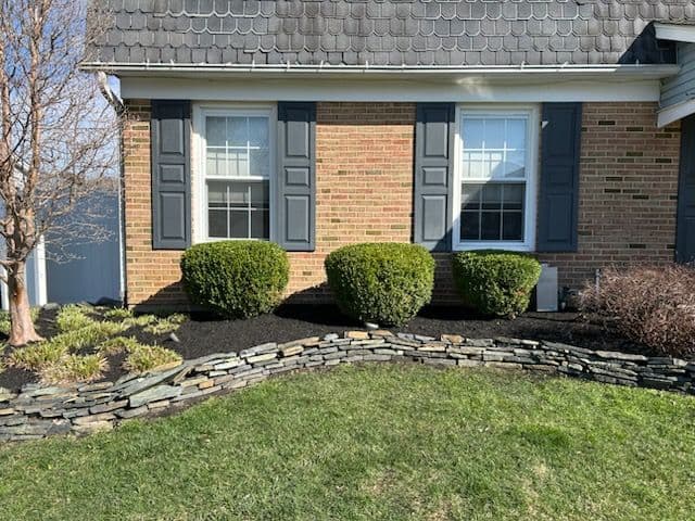 Residential Landscaping with Black Mulch and Trimming